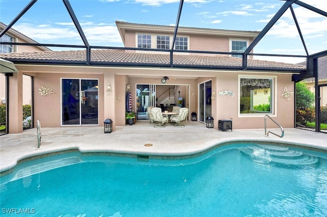 28686 San Galgano Way, Bonita Springs, FL 34135 - back of house with a patio, a lanai, stucco siding, and an outdoor pool