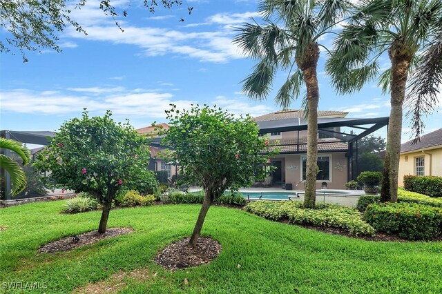28686 San Galgano Way, Bonita Springs, FL 34135 - view of front of home featuring a front lawn, stucco siding, a lanai, an outdoor pool, and a tile roof