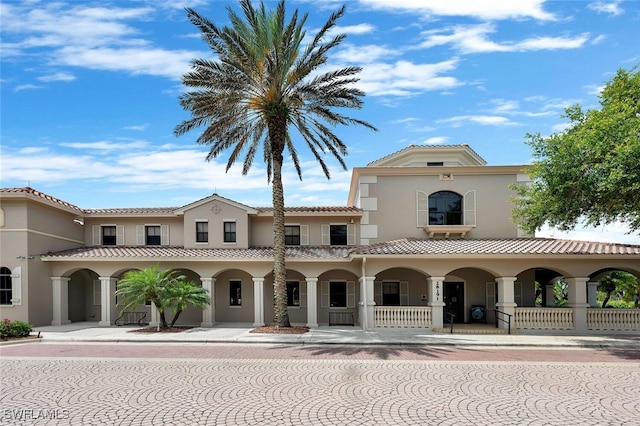 28686 San Galgano Way, Bonita Springs, FL 34135 - view of front facade featuring stucco siding, a porch, and a tile roof