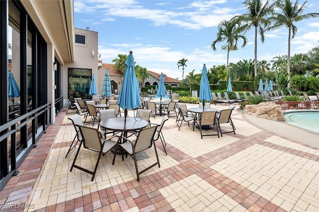 28686 San Galgano Way, Bonita Springs, FL 34135 - view of patio / terrace with outdoor dining area and a community pool