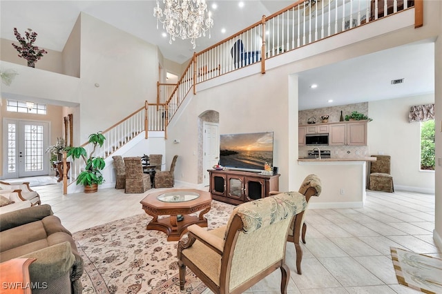 28686 San Galgano Way, Bonita Springs, FL 34135 - living area featuring a high ceiling, stairway, light tile patterned floors, a chandelier, and recessed lighting