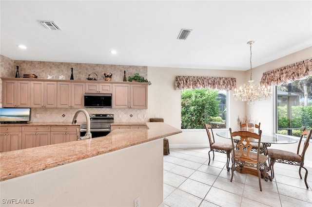 28686 San Galgano Way, Bonita Springs, FL 34135 - kitchen featuring black microwave, stainless steel range with electric cooktop, baseboards, decorative backsplash, and decorative light fixtures