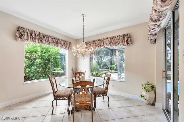 28686 San Galgano Way, Bonita Springs, FL 34135 - dining space with a chandelier, baseboards, and light tile patterned flooring