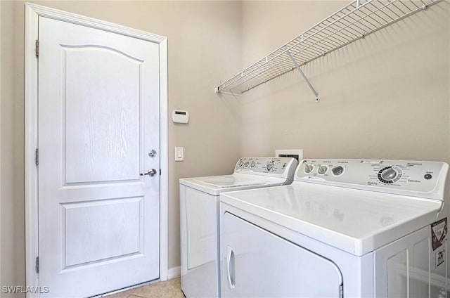 14614 Fern Lake Ct, Naples, FL 34114 - laundry room with washer and dryer, baseboards, and light tile patterned floors