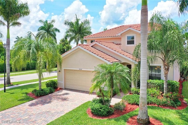 14614 Fern Lake Ct, Naples, FL 34114 - mediterranean / spanish house with a tile roof, stucco siding, an attached garage, decorative driveway, and a front lawn