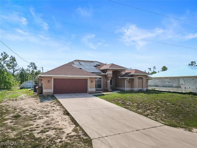 718 Willard Ave, Lehigh Acres, FL 33972 - view of front of home with stucco siding, a garage, solar panels, driveway, and a shed