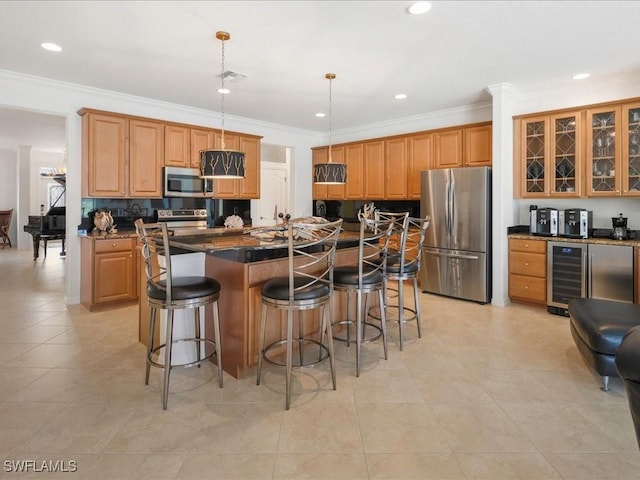 3913 Sapphire Way, Naples, FL 34114 - kitchen featuring stainless steel appliances, dark countertops, a breakfast bar area, a center island, and wine cooler