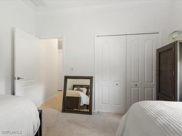 3913 Sapphire Way, Naples, FL 34114 - bedroom featuring a closet, ornamental molding, light carpet, and light tile patterned flooring