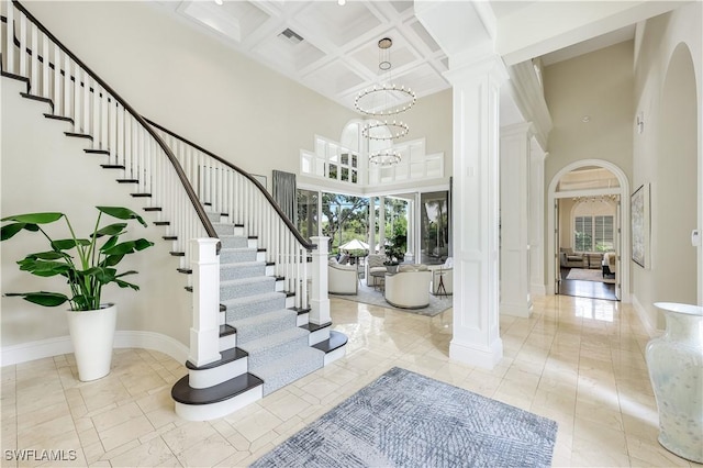 4111 Harbor Oaks Ct, Bonita Springs, FL 34134 - foyer entrance with a towering ceiling, arched walkways, coffered ceiling, decorative columns, and beamed ceiling