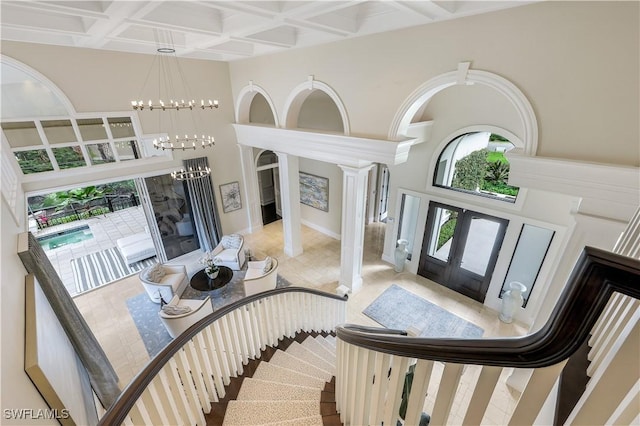 4111 Harbor Oaks Ct, Bonita Springs, FL 34134 - entryway featuring a towering ceiling, french doors, a chandelier, coffered ceiling, and beamed ceiling