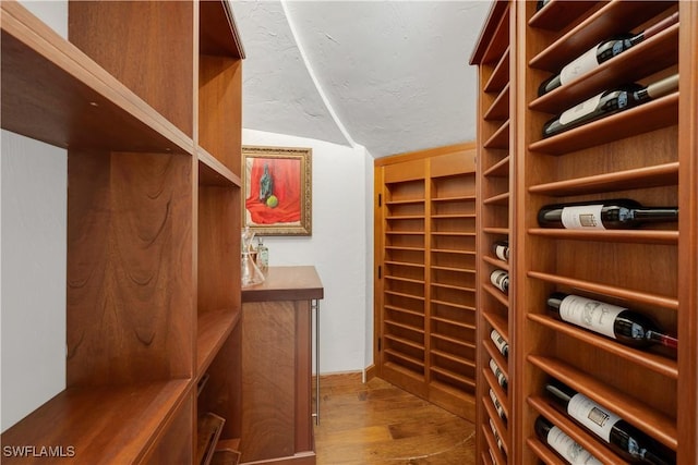 4111 Harbor Oaks Ct, Bonita Springs, FL 34134 - wine room with wood finished floors and vaulted ceiling
