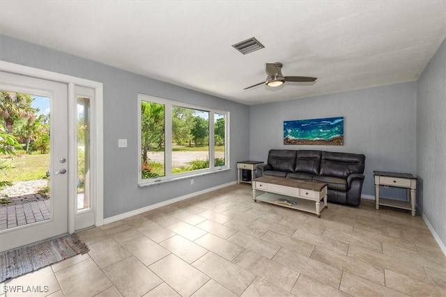13951 Rod And Gun Club Rd, Fort Myers, FL 33913 - living room with healthy amount of natural light, a ceiling fan, and baseboards