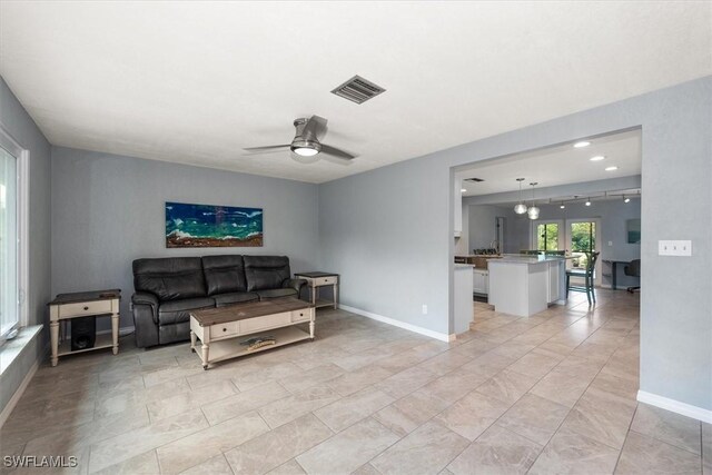 13951 Rod And Gun Club Rd, Fort Myers, FL 33913 - living area featuring a ceiling fan and baseboards