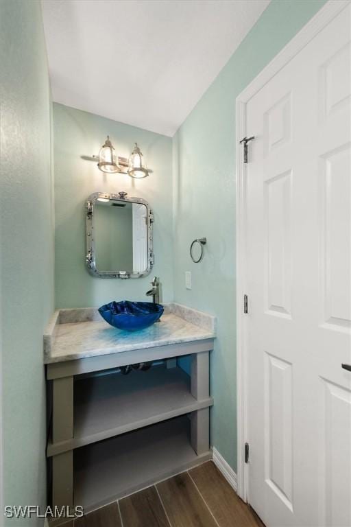 13951 Rod And Gun Club Rd, Fort Myers, FL 33913 - bathroom featuring wood finished floors, vanity, and baseboards