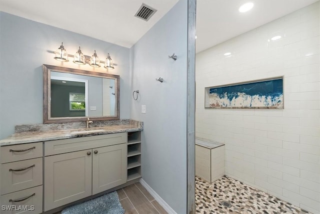 13951 Rod And Gun Club Rd, Fort Myers, FL 33913 - bathroom with vanity, a tile shower, baseboards, and wood finished floors