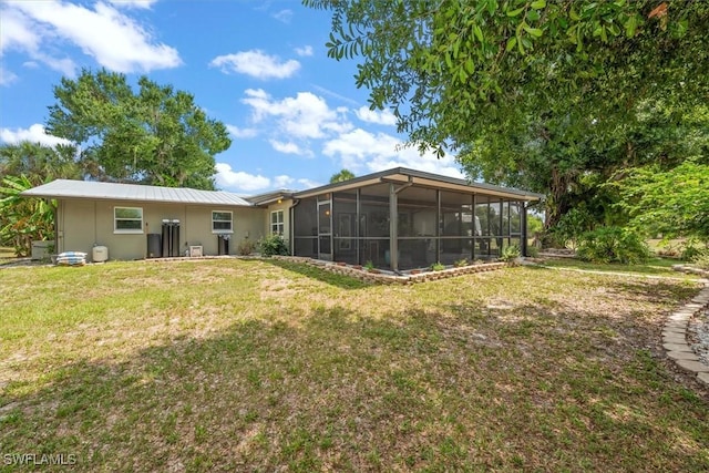 13951 Rod And Gun Club Rd, Fort Myers, FL 33913 - rear view of property with a sunroom and a lawn