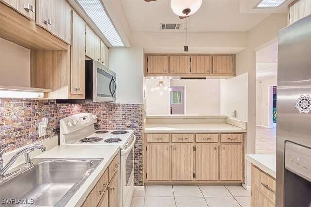 8061 S Woods Cir Unit 4, Fort Myers, FL 33919 - kitchen with appliances with stainless steel finishes, a sink, light countertops, and light tile patterned floors