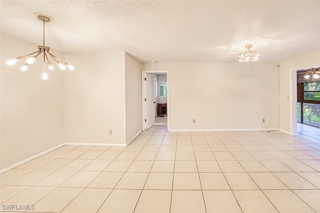 8061 S Woods Cir Unit 4, Fort Myers, FL 33919 - unfurnished room featuring a chandelier, a textured ceiling, baseboards, and light tile patterned floors