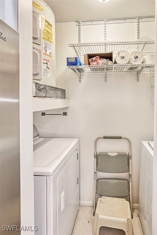8061 S Woods Cir Unit 4, Fort Myers, FL 33919 - laundry area featuring washer and clothes dryer and baseboards