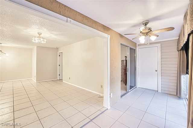 8061 S Woods Cir Unit 4, Fort Myers, FL 33919 - spare room with light tile patterned flooring, a chandelier, ceiling fan, and a textured ceiling
