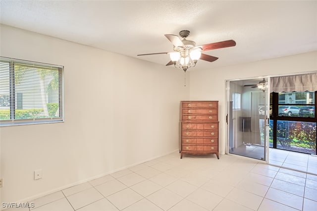 8061 S Woods Cir Unit 4, Fort Myers, FL 33919 - empty room featuring a ceiling fan, light tile patterned flooring, and baseboards