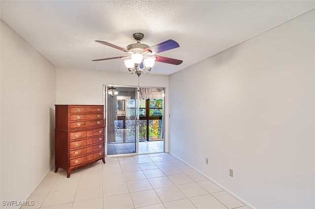 8061 S Woods Cir Unit 4, Fort Myers, FL 33919 - spare room with ceiling fan, baseboards, a textured ceiling, and light tile patterned floors