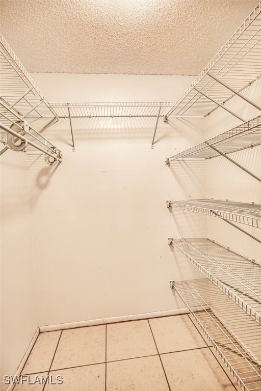 8061 S Woods Cir Unit 4, Fort Myers, FL 33919 - spacious closet featuring tile patterned floors