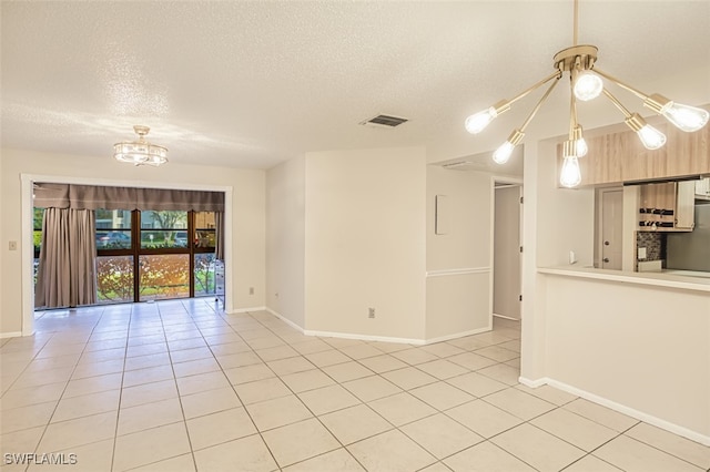 8061 S Woods Cir Unit 4, Fort Myers, FL 33919 - unfurnished room with light tile patterned floors, a textured ceiling, a chandelier, and baseboards