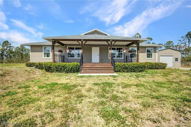 6405 Alan Blvd, Punta Gorda, FL 33982 - view of front facade featuring covered porch, a front yard, a detached garage, and an outdoor structure