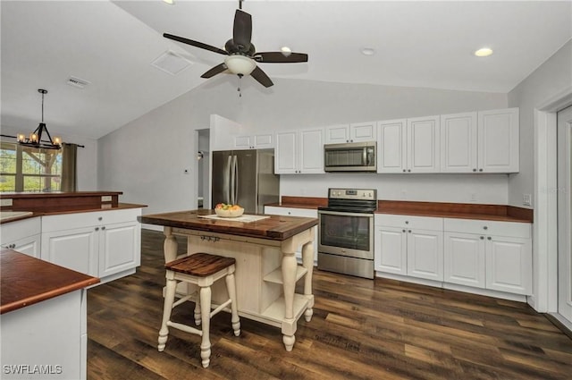 6405 Alan Blvd, Punta Gorda, FL 33982 - kitchen with appliances with stainless steel finishes, wooden counters, lofted ceiling, a chandelier, and dark wood-style floors