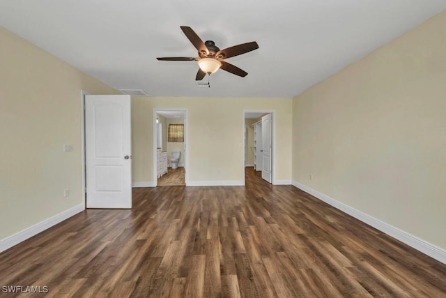 6405 Alan Blvd, Punta Gorda, FL 33982 - unfurnished bedroom with dark wood-style flooring, a walk in closet, ensuite bathroom, ceiling fan, and a closet