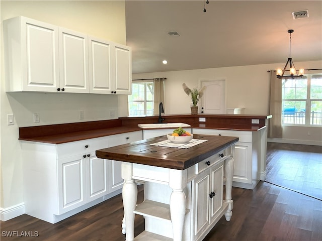 6405 Alan Blvd, Punta Gorda, FL 33982 - kitchen featuring a peninsula, a chandelier, wood counters, dark wood finished floors, and recessed lighting