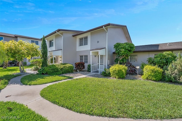 180 Cypress Way E Unit D124, Naples, FL 34110 - rear view of property with a yard and stucco siding