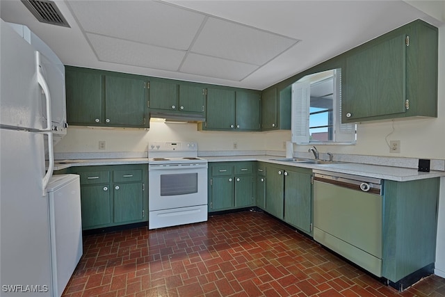 180 Cypress Way E Unit D124, Naples, FL 34110 - kitchen with white appliances, a sink, brick patterned floors, and green cabinetry