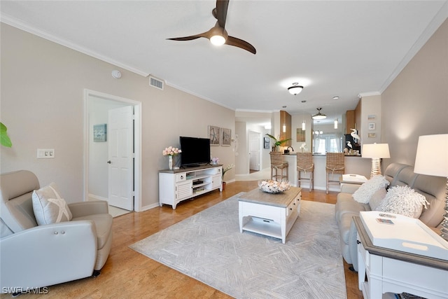 7058 Barrington Cir Unit 102, Naples, FL 34108 - living area with a ceiling fan, crown molding, light wood finished floors, and baseboards