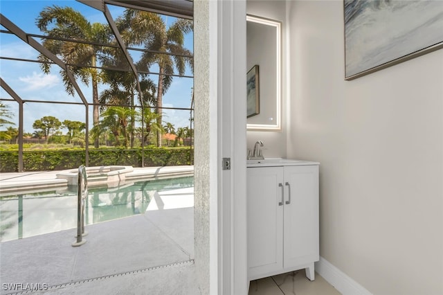 2722 Olde Cypress Dr, Naples, FL 34119 - outdoor pool featuring a sink, glass enclosure, and a patio
