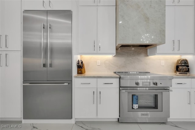 2722 Olde Cypress Dr, Naples, FL 34119 - kitchen with stainless steel appliances, light marble finish floors, and white cabinetry