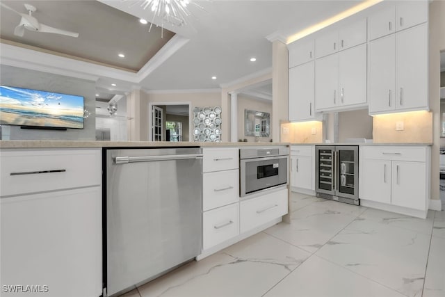 2722 Olde Cypress Dr, Naples, FL 34119 - kitchen featuring beverage cooler, appliances with stainless steel finishes, recessed lighting, white cabinets, and ornamental molding