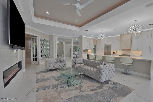 2722 Olde Cypress Dr, Naples, FL 34119 - living area with a tray ceiling, recessed lighting, ceiling fan, light marble finish floors, and ornamental molding