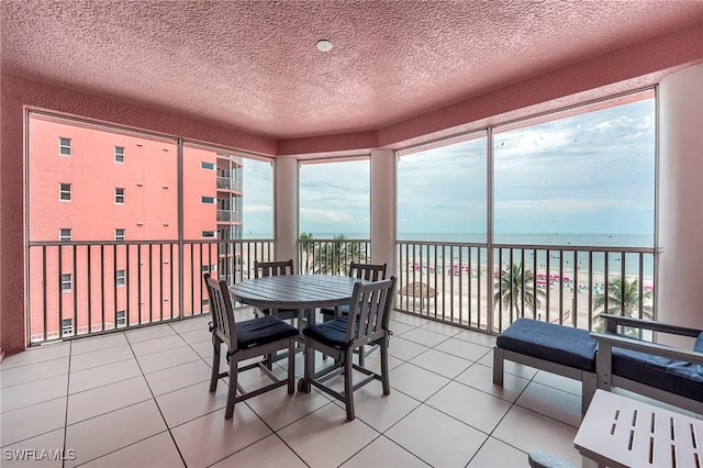 190 Estero Blvd Unit 303, Fort Myers Beach, FL 33931 - tiled dining space featuring a water view and a textured ceiling
