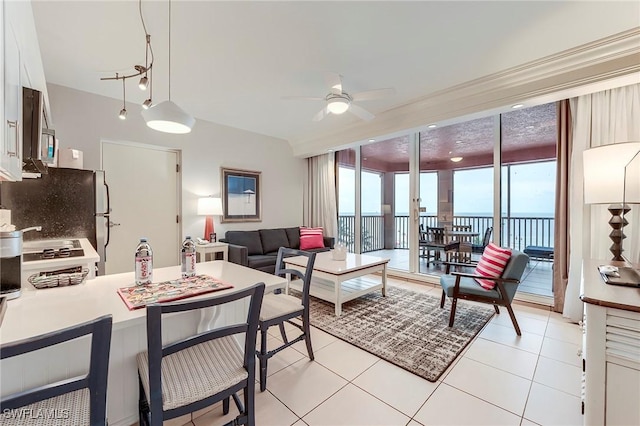 190 Estero Blvd Unit 303, Fort Myers Beach, FL 33931 - living area featuring ceiling fan, light tile patterned floors, and a water view