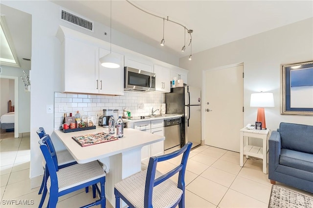 190 Estero Blvd Unit 303, Fort Myers Beach, FL 33931 - kitchen featuring stainless steel appliances, light countertops, backsplash, and light tile patterned floors