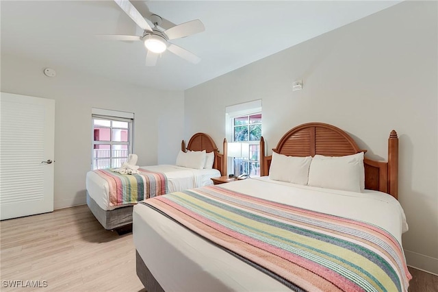190 Estero Blvd Unit 303, Fort Myers Beach, FL 33931 - bedroom with multiple windows, light wood-type flooring, a ceiling fan, and baseboards