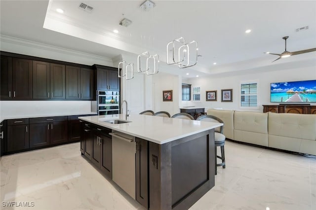 2488 Breakwater Way Unit 201, Naples, FL 34112 - kitchen featuring a tray ceiling, stainless steel dishwasher, a kitchen bar, light countertops, and recessed lighting