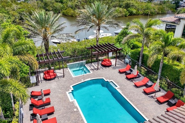 2488 Breakwater Way Unit 201, Naples, FL 34112 - community pool with a pergola, a water view, a patio, and view of scattered trees