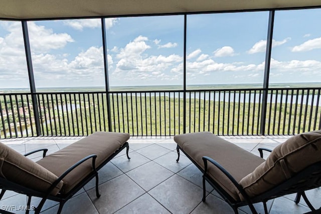 1050 Borghese Ln Unit 1101, Naples, FL 34114 - sunroom / solarium with a water view, tile patterned flooring, and expansive windows
