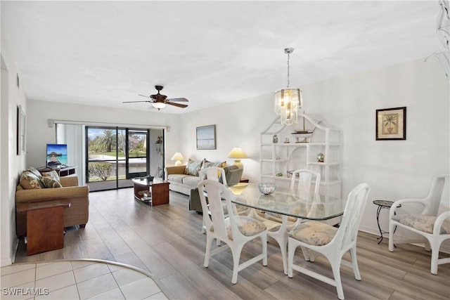 1010 SW 48th Ter Unit 102, Cape Coral, FL 33914 - dining area with light wood-type flooring, ceiling fan, and a chandelier