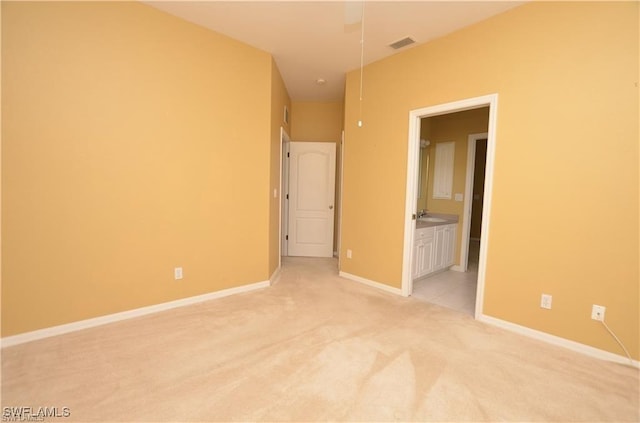 1820 SW 29th Ter, Cape Coral, FL 33914 - unfurnished bedroom with light colored carpet, baseboards, ensuite bathroom, and a sink