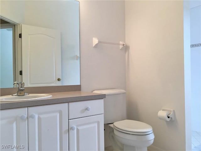 1820 SW 29th Ter, Cape Coral, FL 33914 - bathroom with toilet, vanity, and baseboards