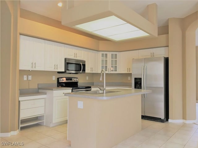 1820 SW 29th Ter, Cape Coral, FL 33914 - kitchen featuring stainless steel appliances, a sink, light tile patterned floors, a kitchen island with sink, and white cabinets